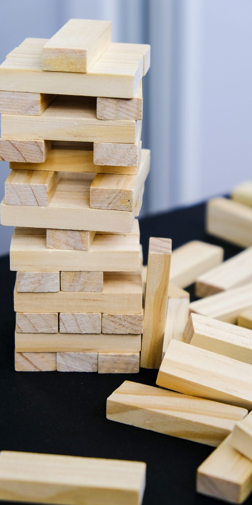 Building from wooden blocks. Game for family of wooden bars. Wood blocks stack game with Hand Building from wooden blocks. Game for family of wooden bars. Wood blocks stack game with Hand